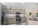 Well-equipped kitchen with stainless steel appliances and spacious countertops, ready for cooking at 9966 Hidden Dunes Ln, Orlando, FL 32832