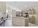 Bright kitchen with stainless steel appliances, painted cabinets, and tiled floors at 9966 Hidden Dunes Ln, Orlando, FL 32832