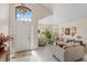 Bright living room with high ceiling, white tiled floor, neutral furniture and lots of natural light at 9966 Hidden Dunes Ln, Orlando, FL 32832