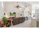 This living room features high ceilings, a mounted TV, rustic furniture, a staircase, and a breakfast bar at 9966 Hidden Dunes Ln, Orlando, FL 32832