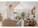 Bright living room with high ceiling, white tiled floor, neutral furniture and lots of natural light at 9966 Hidden Dunes Ln, Orlando, FL 32832