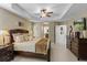 This main bedroom features a tray ceiling and exits to the main bathroom and hallways at 9966 Hidden Dunes Ln, Orlando, FL 32832