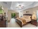This main bedroom features a tray ceiling and a sliding door exit to the backyard at 9966 Hidden Dunes Ln, Orlando, FL 32832