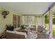 Inviting covered patio with slate flooring, comfortable wicker furniture, and views of the backyard at 9966 Hidden Dunes Ln, Orlando, FL 32832