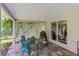 Cozy outdoor patio with slate flooring, decorative lattice, and comfortable seating near a large sliding window at 9966 Hidden Dunes Ln, Orlando, FL 32832
