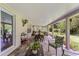 Spacious, covered patio with slate flooring, multiple seating areas, and a view of the private backyard at 9966 Hidden Dunes Ln, Orlando, FL 32832