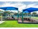 Colorful community playground with swings and climbing structures at 9966 Hidden Dunes Ln, Orlando, FL 32832