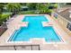 Community pool featuring shallow areas and surrounded by brick patio and sun loungers at 9966 Hidden Dunes Ln, Orlando, FL 32832