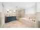 An elegant bathroom featuring a walk-in shower, a soaking tub, and a custom vanity at 1011 Lake Davis Dr, Orlando, FL 32806