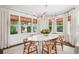Bright dining room featuring a marble table, modern chandelier, and window views at 1011 Lake Davis Dr, Orlando, FL 32806