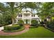 Charming two-story home with a welcoming front porch, manicured landscaping, and a vibrant green front door at 1011 Lake Davis Dr, Orlando, FL 32806