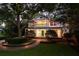 Gorgeous two-story house featuring a spacious porch and a lush landscaped lawn at 1011 Lake Davis Dr, Orlando, FL 32806