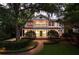 Beautiful two-story home with a welcoming porch, and lush, mature landscaping at 1011 Lake Davis Dr, Orlando, FL 32806