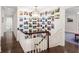 Bright hallway with white wainscoting and a gallery wall leading up to the second floor at 1011 Lake Davis Dr, Orlando, FL 32806