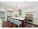 Gourmet kitchen featuring a large island, marble countertops, stainless steel appliances, and custom cabinetry at 1011 Lake Davis Dr, Orlando, FL 32806