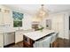Well-appointed kitchen with a large island, marble backsplash, stainless steel appliances, and a bright window at 1011 Lake Davis Dr, Orlando, FL 32806