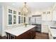Elegant kitchen featuring custom cabinets, stainless steel appliances, and a center island with bar seating at 1011 Lake Davis Dr, Orlando, FL 32806