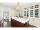 Charming kitchen featuring a center island with seating, custom cabinets, and a view into the living area at 1011 Lake Davis Dr, Orlando, FL 32806