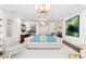 Spacious living area with chic seating arrangements, artwork, and recessed lighting under a coffered ceiling at 1011 Lake Davis Dr, Orlando, FL 32806
