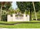 Lake Davis neighborhood sign with manicured landscaping and an American flag in the background at 1011 Lake Davis Dr, Orlando, FL 32806