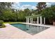 Beautiful pool with patio area, pergola, and manicured landscaping at 1011 Lake Davis Dr, Orlando, FL 32806