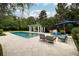 Gorgeous pool with outdoor kitchen, seating, and privacy landscaping at 1011 Lake Davis Dr, Orlando, FL 32806