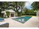 Picturesque pool and outdoor lounging area with covered patio at 1011 Lake Davis Dr, Orlando, FL 32806