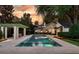 Inviting pool area with lush landscaping, a pergola and an outdoor dining area at 1011 Lake Davis Dr, Orlando, FL 32806