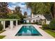 Beautiful backyard featuring a rectangular pool, patio furniture, and a well-manicured lawn surrounded by lush greenery at 1011 Lake Davis Dr, Orlando, FL 32806