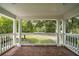Charming front porch with brick flooring and stately columns at 1011 Lake Davis Dr, Orlando, FL 32806
