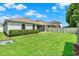 Exterior view of a backyard and patio in a well-maintained lawn at 1061 Castlevecchio Loop, Orlando, FL 32825