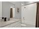 Bright bathroom featuring a shower-tub combo with tile surround and a granite vanity at 1061 Castlevecchio Loop, Orlando, FL 32825