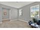 An empty bedroom, freshly painted with natural light coming in through large windows, and plush carpeting at 1061 Castlevecchio Loop, Orlando, FL 32825