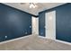 Cozy bedroom featuring carpeted floors, neutral colors, and a white door at 1061 Castlevecchio Loop, Orlando, FL 32825