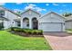 Charming single-Gathering home with a well-manicured lawn, brick driveway, and inviting curb appeal at 1061 Castlevecchio Loop, Orlando, FL 32825