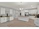 Bright, open kitchen with stainless steel appliances, granite countertops, and luxury vinyl plank flooring at 1061 Castlevecchio Loop, Orlando, FL 32825