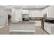 Bright kitchen with white cabinets, granite counters, stainless appliances, and luxury vinyl plank flooring at 1061 Castlevecchio Loop, Orlando, FL 32825