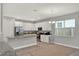 Bright kitchen featuring white cabinets, stainless steel appliances, and granite countertops at 1061 Castlevecchio Loop, Orlando, FL 32825