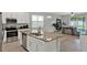 Open kitchen with stainless steel appliances, granite countertops, and an island sink overlooking the living area at 1061 Castlevecchio Loop, Orlando, FL 32825