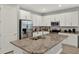 Modern kitchen features stainless appliances, white cabinets, granite countertops, and an eat-in island with a sink at 1061 Castlevecchio Loop, Orlando, FL 32825