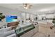 Inviting living room with neutral colors, wood floors and a view into kitchen at 1061 Castlevecchio Loop, Orlando, FL 32825