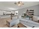 Inviting living room with neutral colors, wood floors and a view into kitchen at 1061 Castlevecchio Loop, Orlando, FL 32825