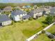 Aerial view of a home with a large backyard with a covered patio, white picket fence, and lush green lawn at 10640 Tibbett St, Orlando, FL 32832