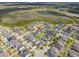 Aerial view of a neighborhood with manicured lawns, mature trees, ponds, and a highway nearby at 10640 Tibbett St, Orlando, FL 32832