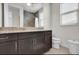 Bathroom with dark wood vanity, granite countertops and modern fixtures at 10640 Tibbett St, Orlando, FL 32832