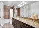 Elegant bathroom featuring dark wood vanity with granite countertops and modern fixtures at 10640 Tibbett St, Orlando, FL 32832