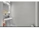 Clean half bath featuring a pedestal sink and modern fixtures in a neutral color palette at 10640 Tibbett St, Orlando, FL 32832