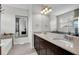 Bathroom featuring double sinks, granite countertops, a large mirror, and a separate tub at 10640 Tibbett St, Orlando, FL 32832