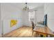 Bright bedroom featuring wood floors, a desk and a neutral color palette at 10640 Tibbett St, Orlando, FL 32832
