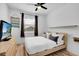 Cozy bedroom with a modern bed, hardwood floors, and a large window at 10640 Tibbett St, Orlando, FL 32832